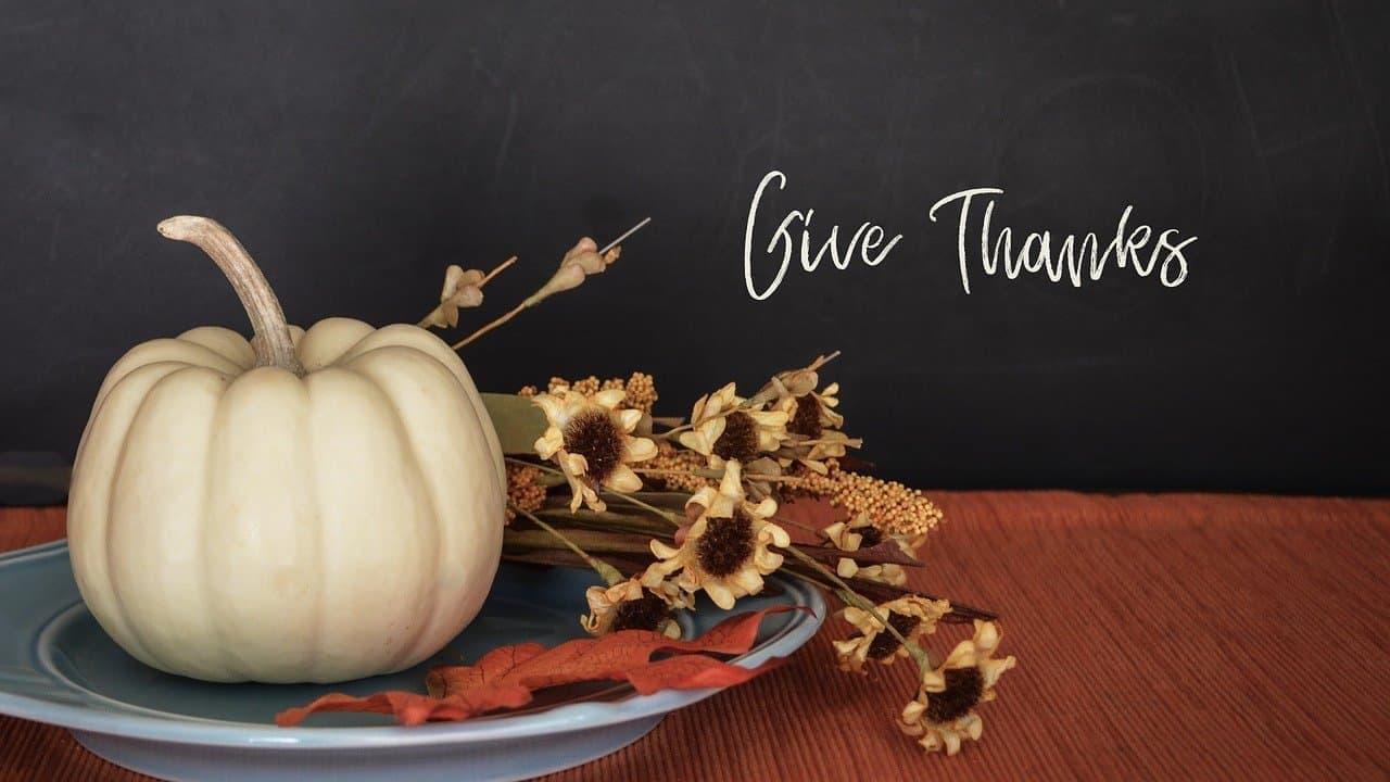 give thanks with a pumpkin and decorations on a plate