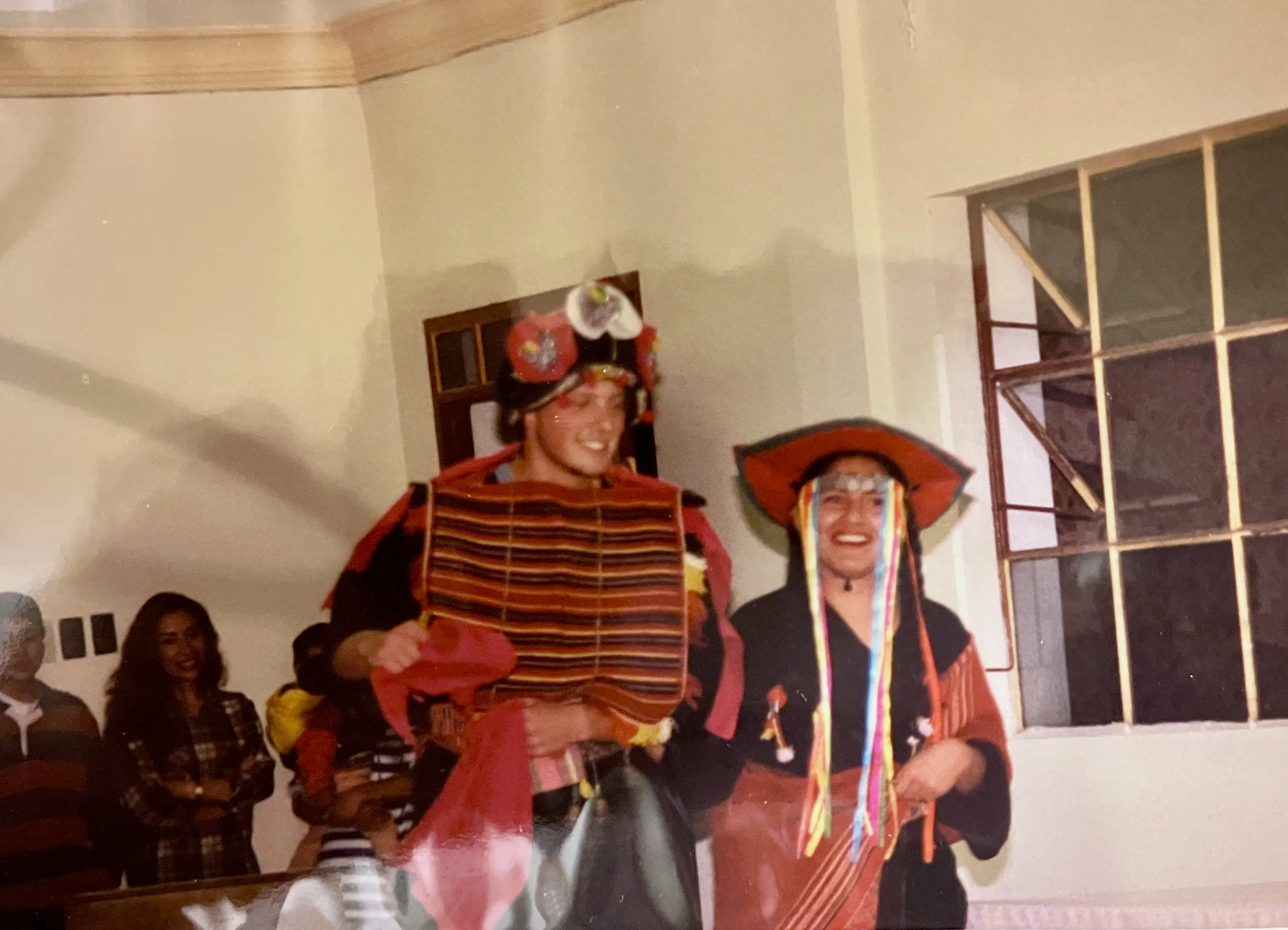 Jason and a friend wearing traditional Bolivian attire during a cultural presentation.